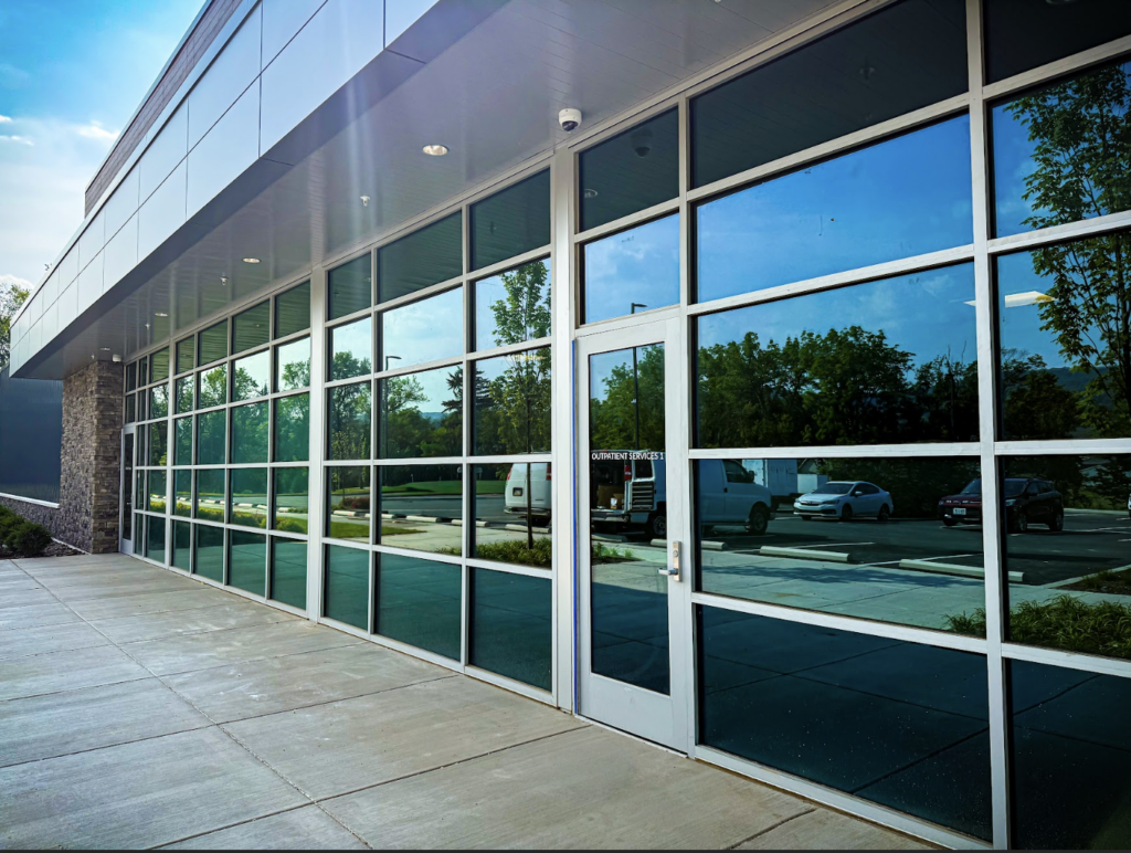 front of a glass office building